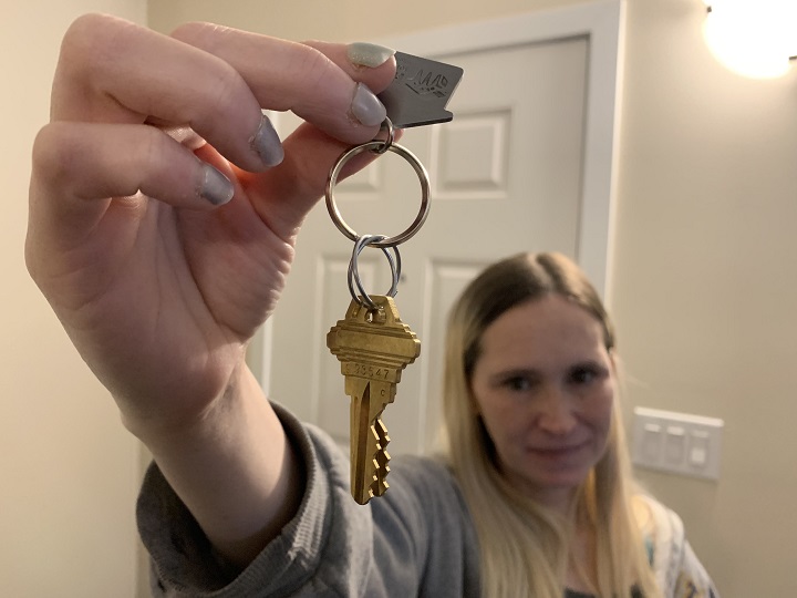 Ashley Patrie holds the key to her new home.