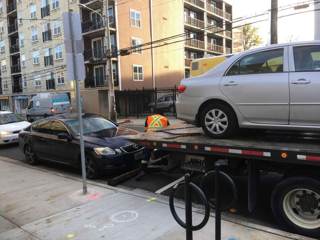 Two vehicles getting towed from Gottingen Street.