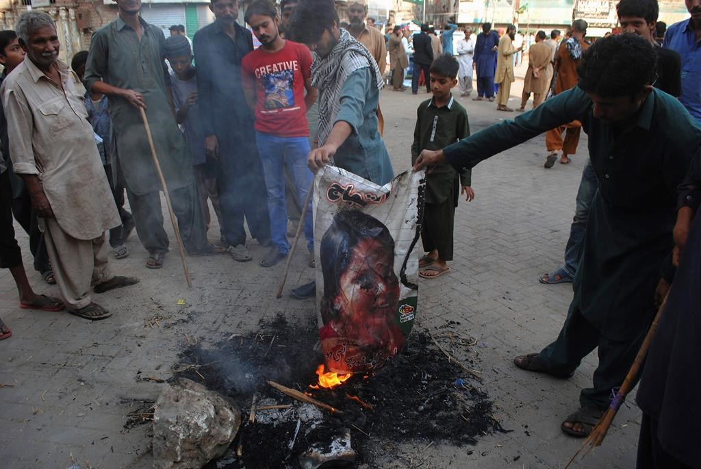 Protesters burn an image of Christian woman Asia Bibi in Hyderabad, Pakistan, Thursday, Nov. 1, 2018.