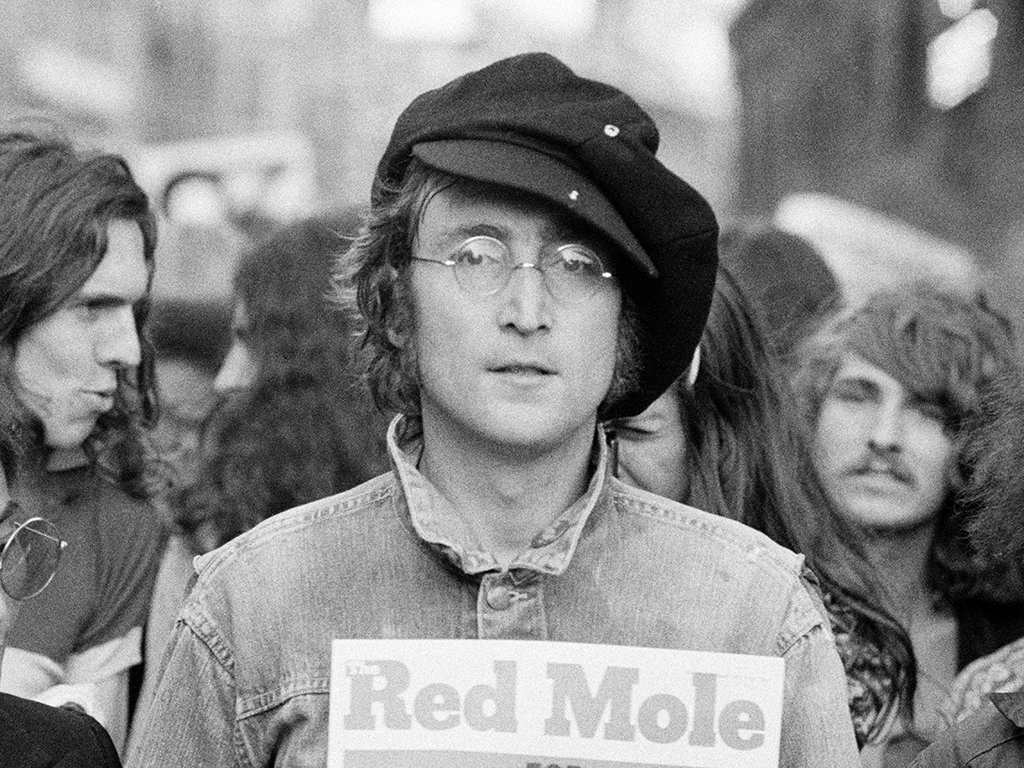 Portrait of British musician John Lennon (1940 - 1980) and Yoko Ono (extreme left) as they attend an unspecified rally in Hyde Park, London, England, 1975. 