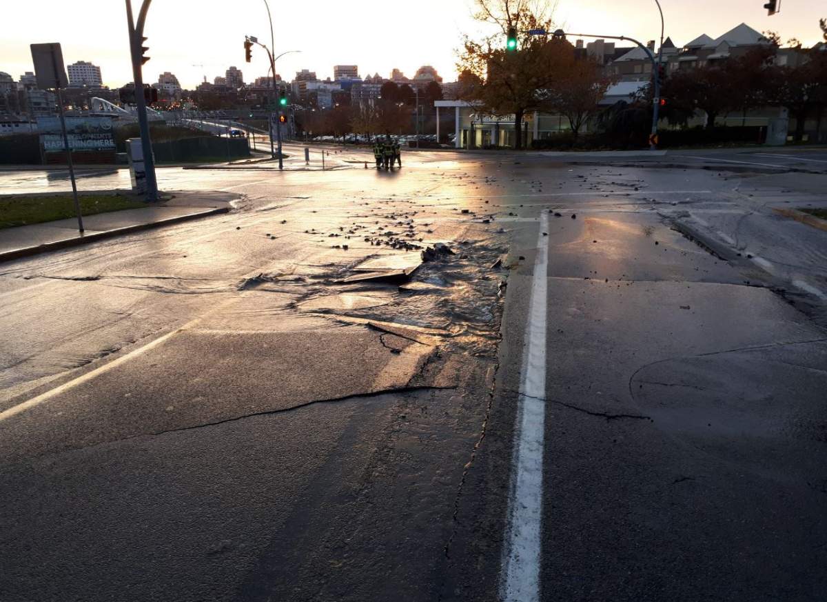 Victoria police and firefighters on scene at a water main break near the Johnson Street Bridge in Victoria Monday.