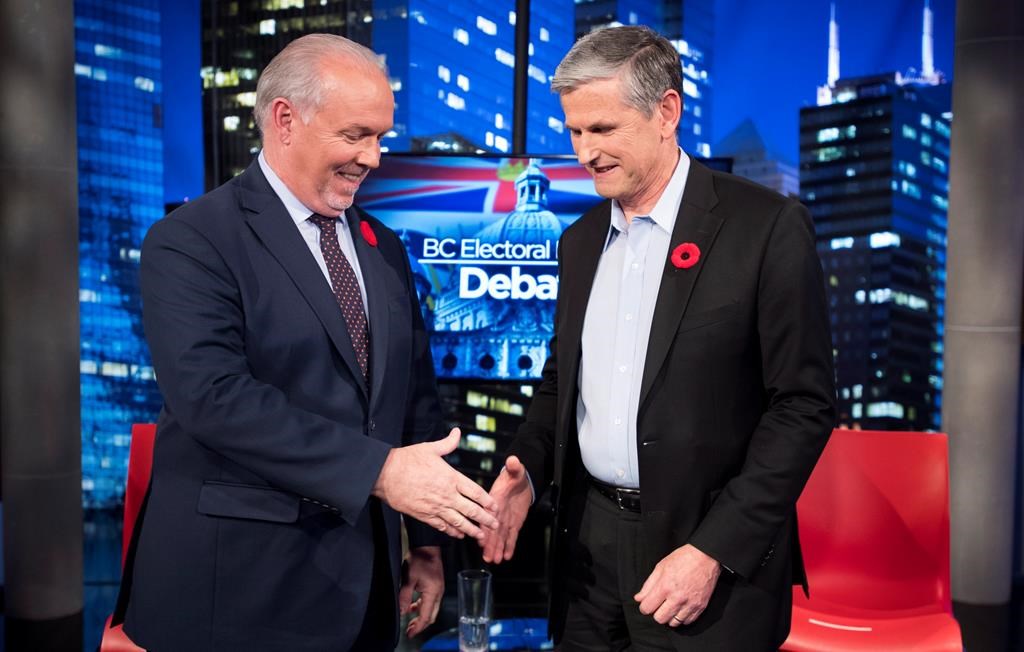 Premier John Horgan and Liberal leader Andrew Wilkinson following the Electoral Reform Debate at Global Television in Burnaby, B.C. Thursday, Nov., 8, 2018. THE CANADIAN PRESS/Jonathan Hayward.