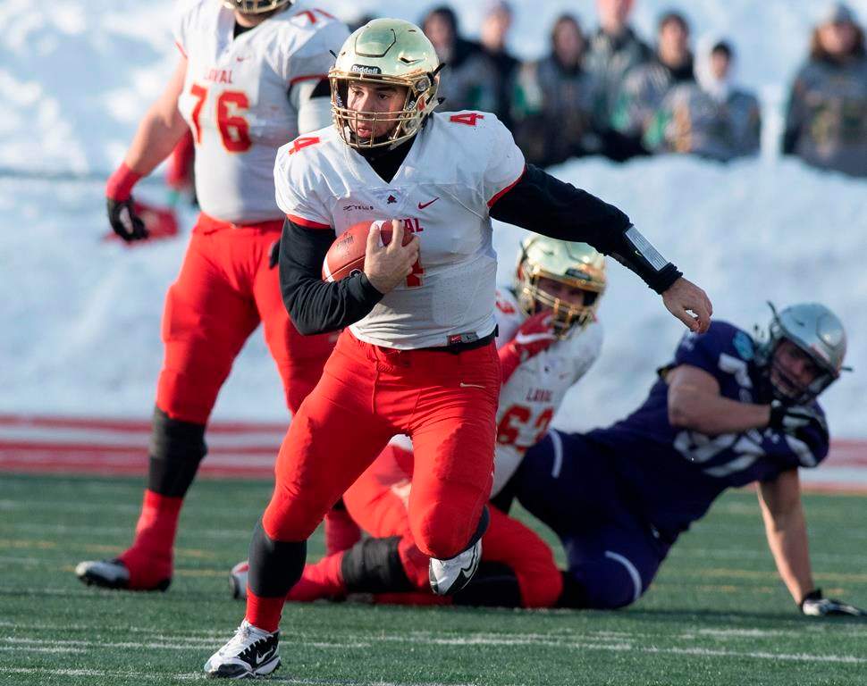 Laval University Rouge et Or's quarterback Hugo Richard runs to a first down against Western University Mustangs during second quarter action of the Vanier Cup final Saturday, November 24, 2018 in Quebec City.