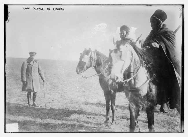 King George V pays his respects to Algerian Spahi soldiers during a visit to the front lines in France