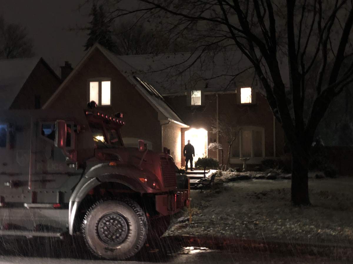 Montreal police officers outside a home in Kirkland following a shooting.