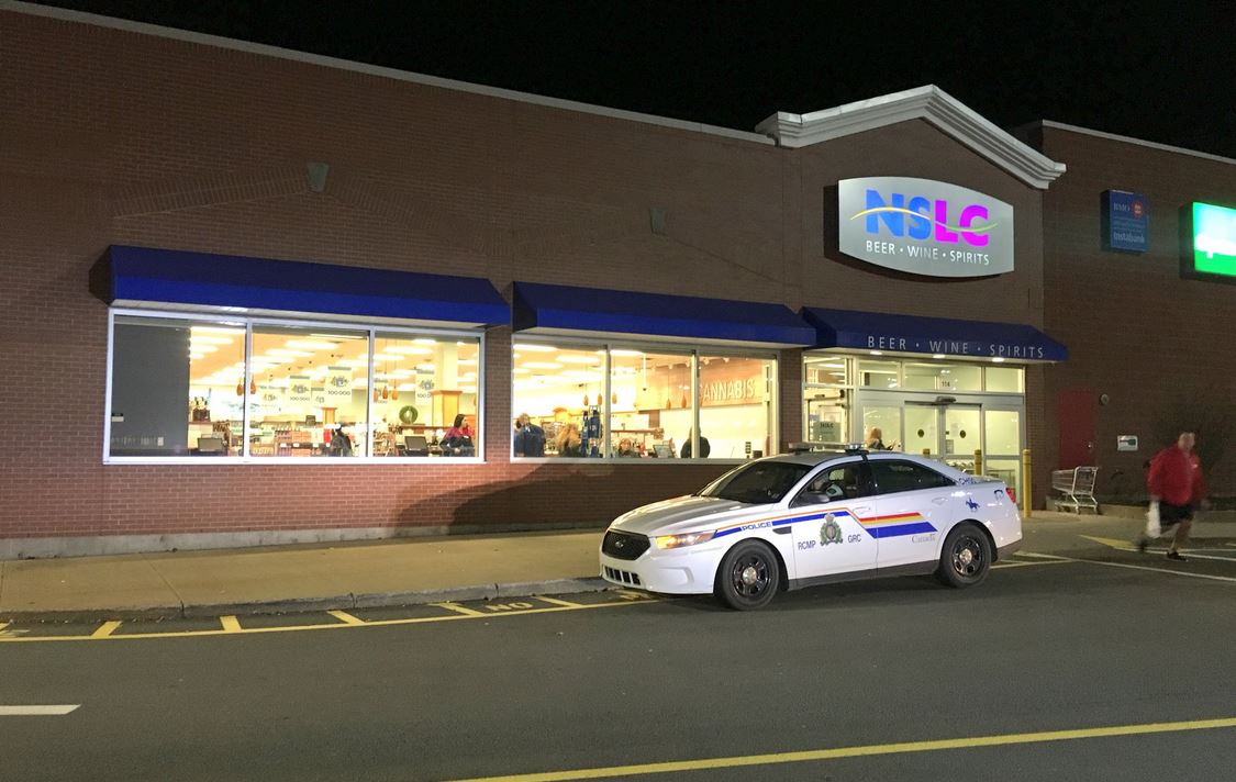 A Nova Scotia RCMP officer attends the scene of an incident at the NSLC location in Lower Sackville, N.S., on Thursday, Nov. 8, 2018. 