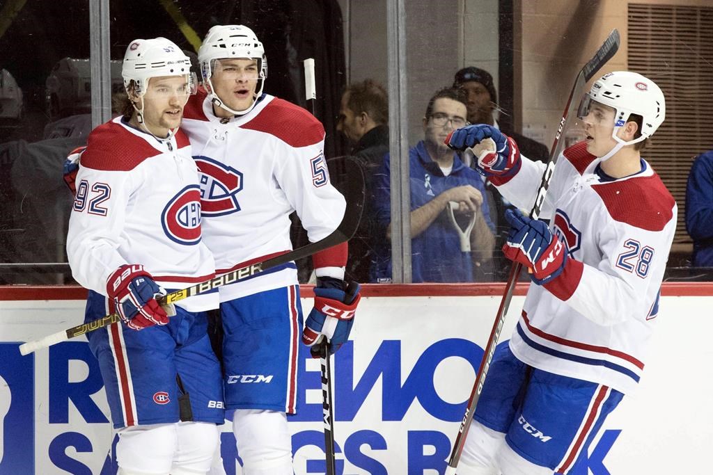 Montreal Canadiens cente Jonathan Drouin, left, celebrates after scoring a goal with his teammates in the first period of an NHL hockey game against the New York Islanders, Monday, Nov. 5, 2018, in New York.