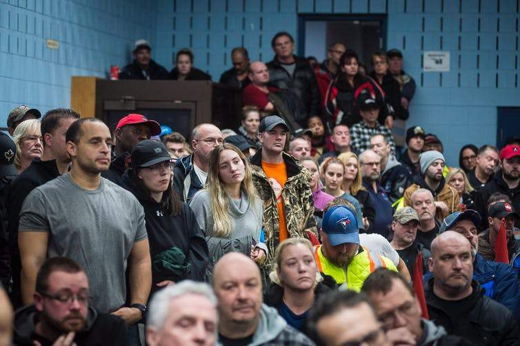 Workers of Oshawa’s General Motors car assembly plant, listen to Jerry Dias, president of UNIFOR, the union representing the workers, at the union headquarters, in Oshawa, Ont. on Monday, Nov. 26, 2018.