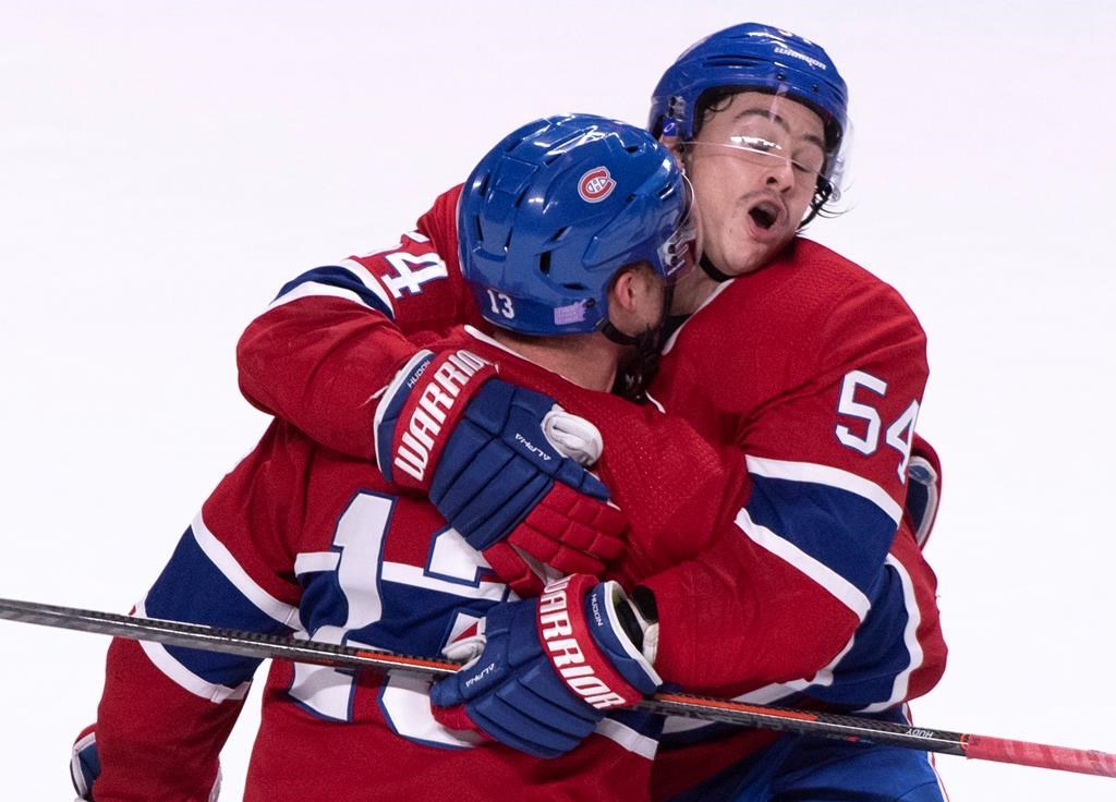 Montreal Canadiens' Charles Hudon hugs teammate Max Domi.