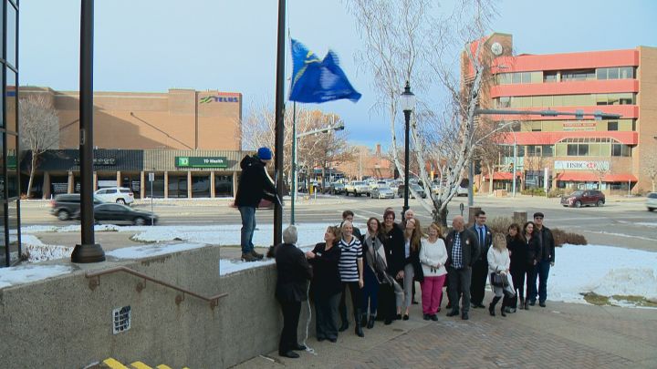 A flag is raised outside of City Hall to commemorate the start of the fourth annual Philanthropy week.