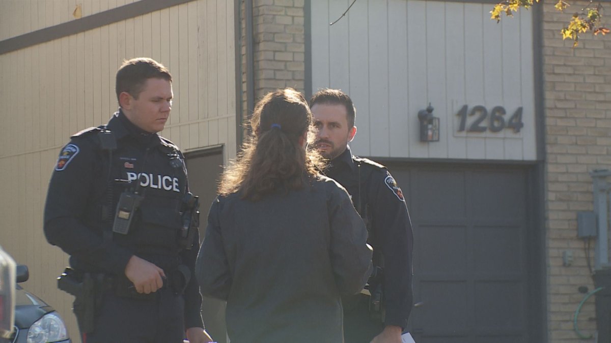 Police speak to residents on Canborough Crescent as they investigate the shooting on the Pickering, Ont., street that happened early Tuesday morning. 