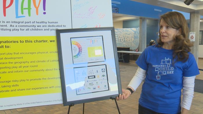 Vicki Hazelwood shows off the City of Lethbridge's new play charter on Saturday.