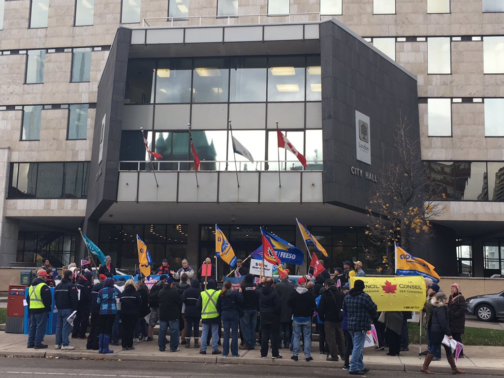 Dozens of people gathered Monday afternoon outside London City Hall in support of postal workers in their labour dispute with Canada Post.