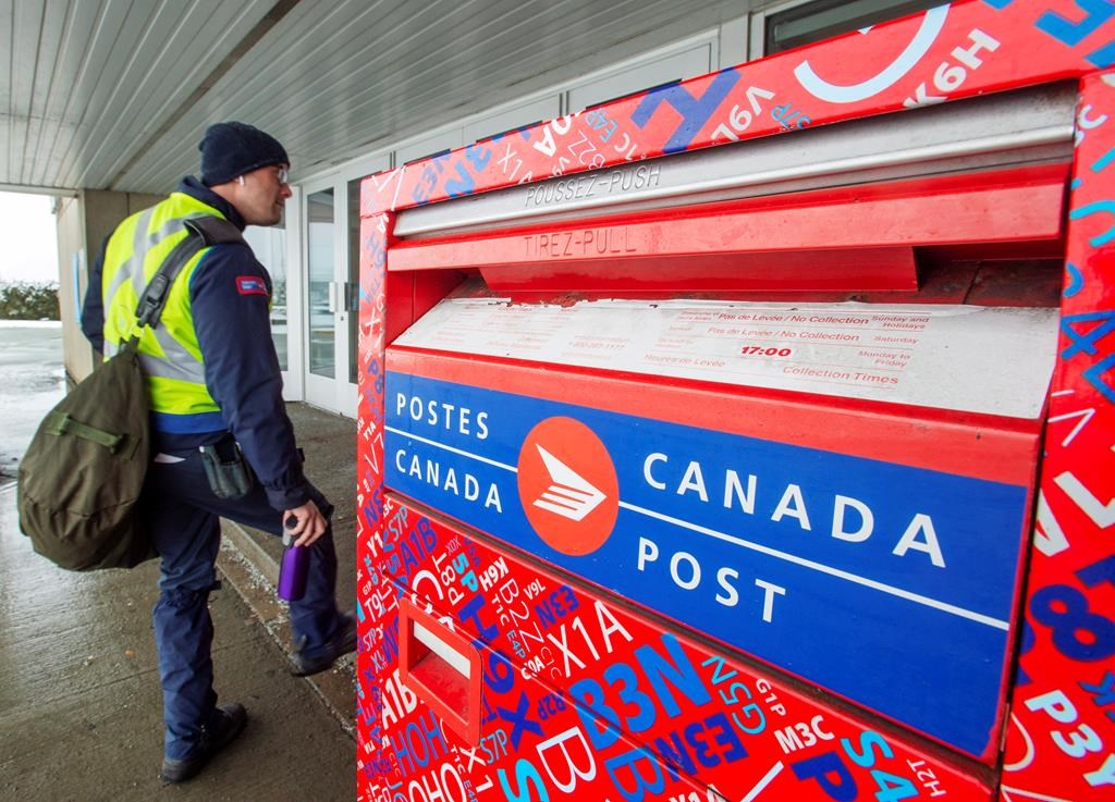 Canada Post workers return to work after the government ordered them to end their rotating strike on Tuesday, Nov. 27, 2018 in Montreal.