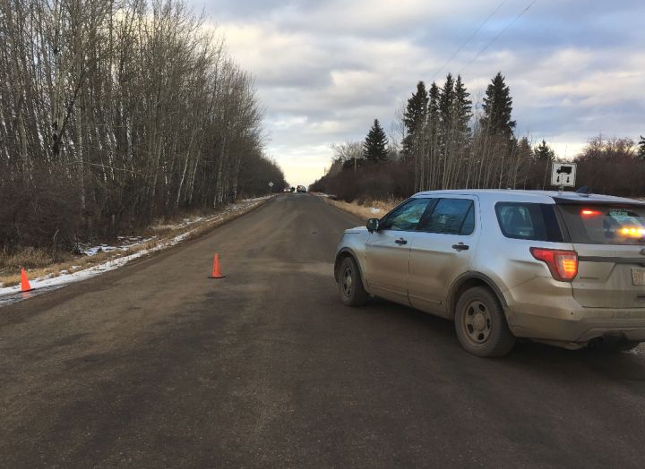 RCMP officers could be seen laying evidence markers in a ditch in Strathcona County on Thursday afternoon. A Global News crew at the scene saw a body pulled from a line of trees planted right beside the road.