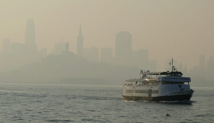 A ferry boat makes its way toward Alcatraz Island as the skyline in the background is obscured by wildfire smoke and haze Monday, Nov. 12, 2018, in San Francisco.