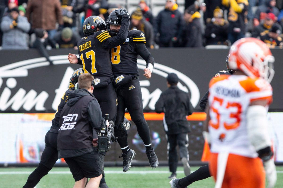 Hamilton Tiger-Cats quarterback Jeremiah Masoli (8) and wide receiver Luke Tasker (17) celebrate after a second touchdown by Tasker during first half CFL Football division semifinal game action against the B.C. Lions in Hamilton, Ont. on Sunday, November 11, 2018.