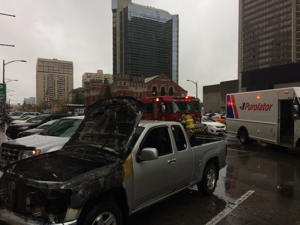 A truck continues to smoulder after bursting into flames in downtown London on Thursday, Nov. 1, 2018.