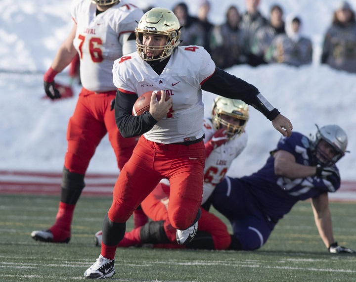 Laval University Rouge et Or's quarterback Hugo Richard runs to a first down against Western University Mustangs during second quarter action of the Vanier Cup final Saturday, November 24, 2018 in Quebec City. 