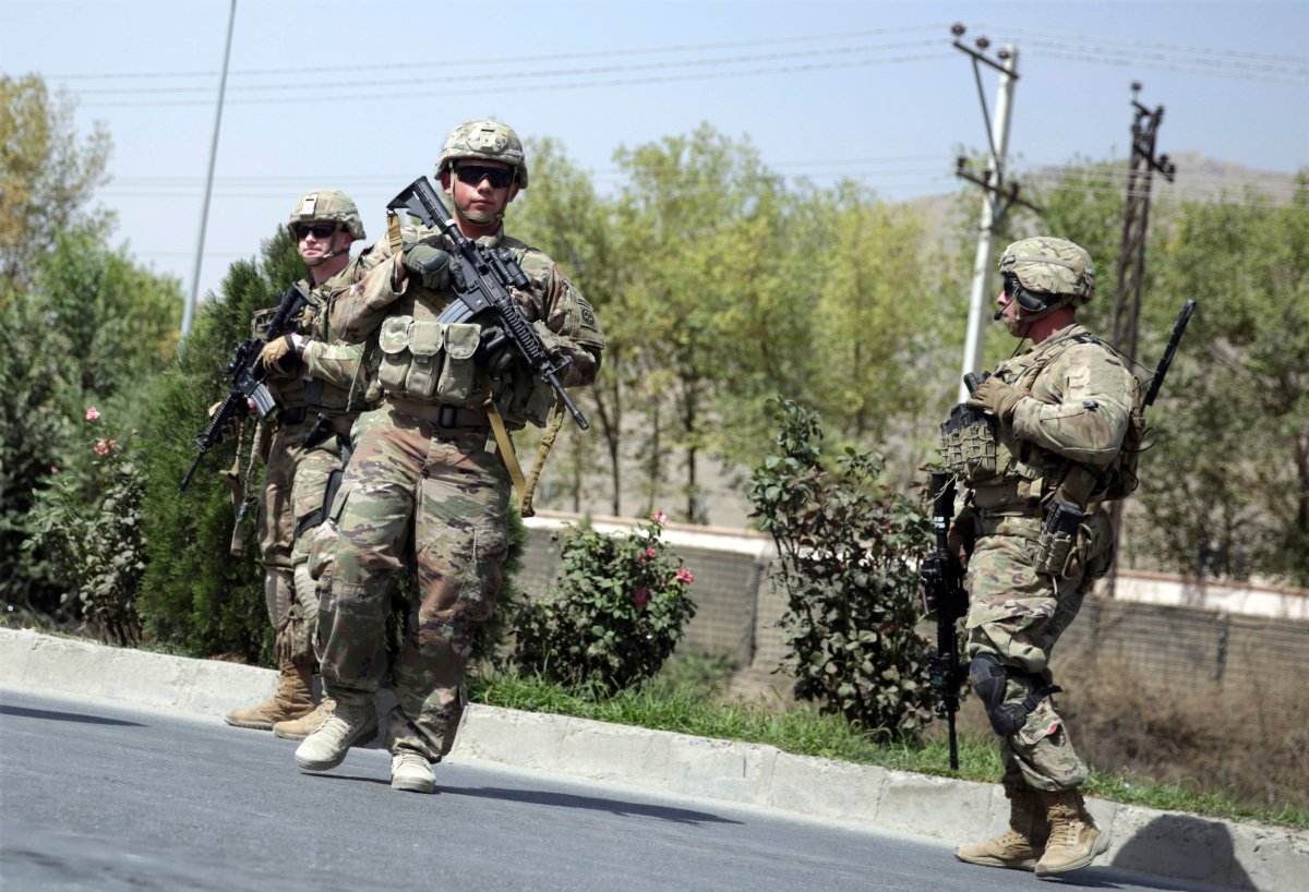 U.S. and Afghan security forces inspect the site of a suicide attack on a NATO convoy in Kabul, Afghanistan, Sept. 24, 2017. Afghanistan's Interior Ministry says a suicide car bomber has struck a convoy of international forces in the capital, wounding several civilians.