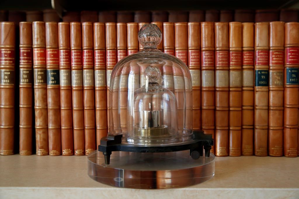 In this photo taken Wednesday, Oct. 17, 2018., a replica of the International Prototype Kilogram is pictured at the International Bureau of Weights and Measures, in Sevres, near Paris. (AP Photo/Christophe Ena)