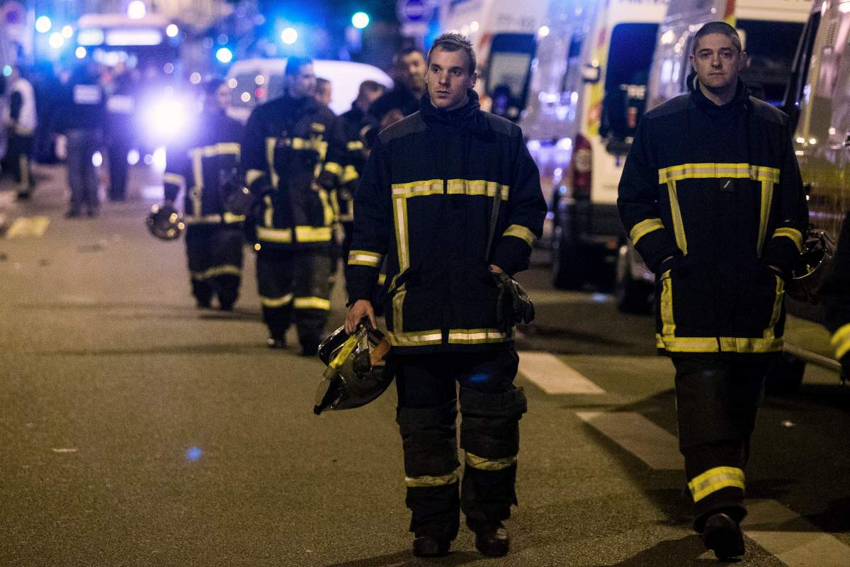 A group of firemen leave the site of the Bataclan where a shooting and an hostage situation took place in Paris, France, 14 November 2015.