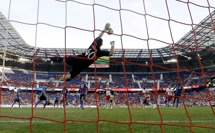 IIn this 2017 file photo, Montreal Impact goalkeeper Maxime Crepeau makes a diving stop on a shot by the New York Red Bulls. Crépeau was traded to the Vancouver Whitecaps on Sunday, Dec. 9, 2018.