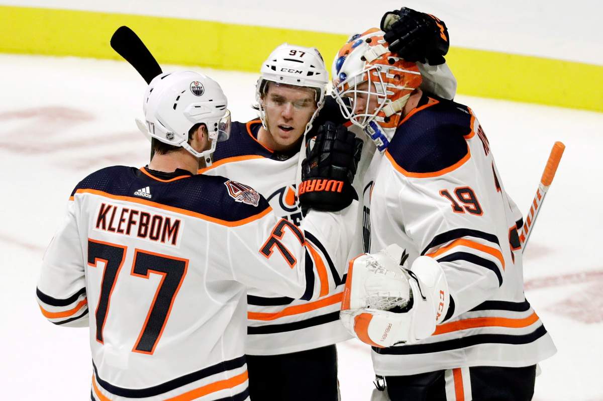 Edmonton Oilers goaltender Mikko Koskinen (19), of Finland, celebrates with defenseman Oscar Klefbom (77), of Sweden, and center Connor McDavid (97) after beating the Nashville Predators 5-3 in an NHL hockey game Saturday, Oct. 27, 2018, in Nashville, Tenn. 