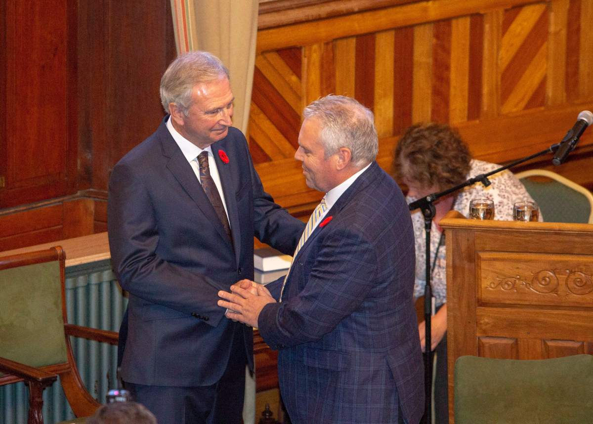 New Brunswick Progressive Conservative MLA Ernie Steeves, right, is sworn in as Minister of Finance, and President of the Treasury Board at the New Brunswick Legislature in Fredericton on Friday, Nov. 9, 2018. 