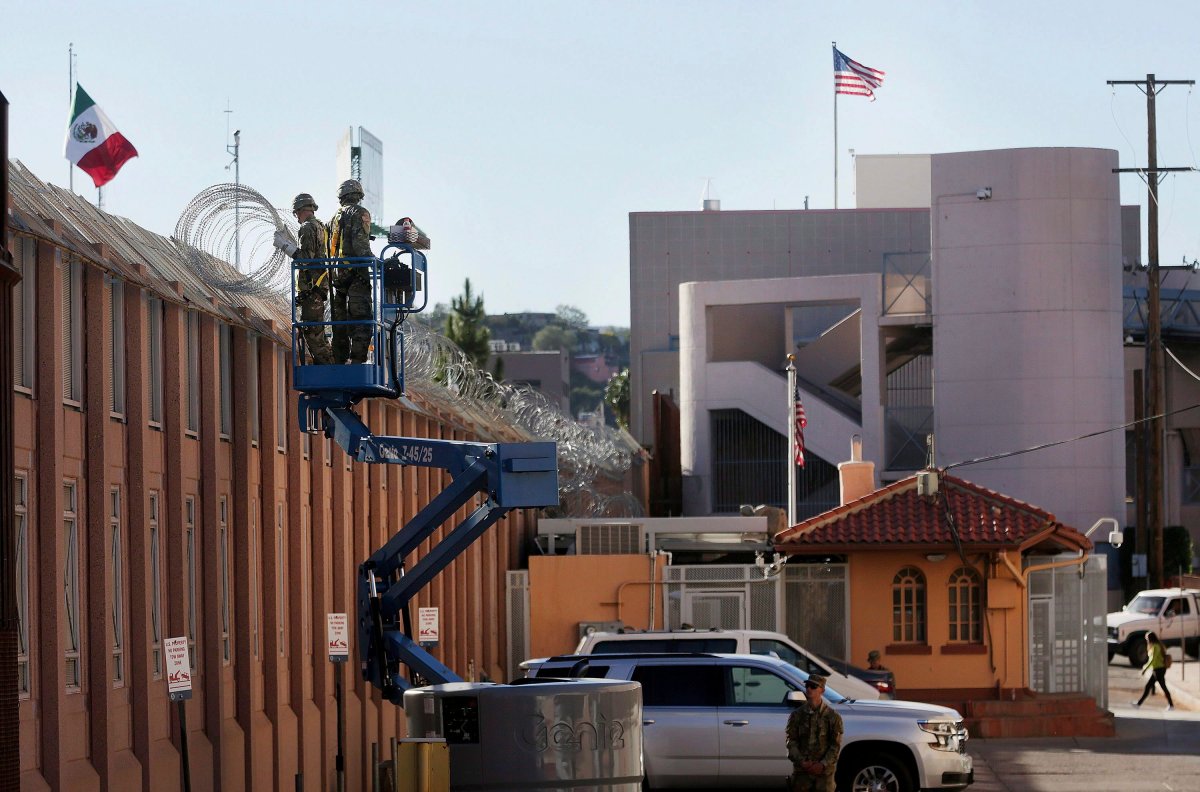 In this Nov. 7, 2018, photo, U.S. Army troops with the 16th Military Police Brigade install concertina wire atop the U.S.-Mexico border near the Morley pedestrian gate just east of the DeConcini Port of Entry in Nogales, Ariz.