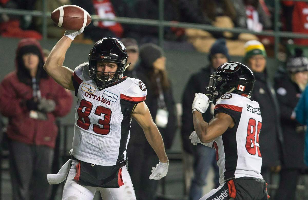 Ottawa Redblacks wide receiver Julian Feoli-Gudino (83) spikes the ball as he celebrates his touchdown with teammate wide receiver Diontae Spencer (85) during the first half of the 106th Grey Cup against the Calgary Stampeders in Edmonton, Sunday, November 25, 2018.