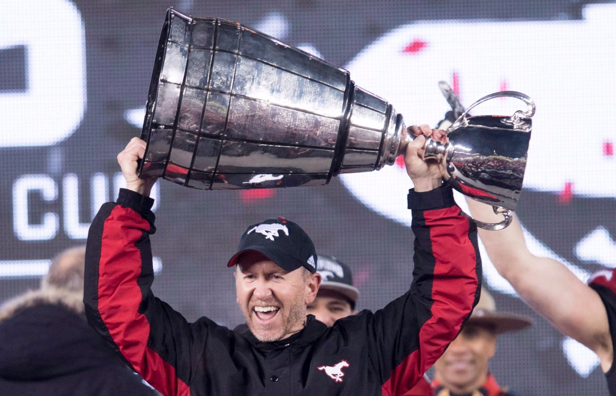 Calgary Stampeders head coach Dave Dickenson hoists the Grey Cup after defeating the Ottawa Redblacks at the 106th Grey Cup in Edmonton, Alta. Sunday, Nov. 25, 2018. 