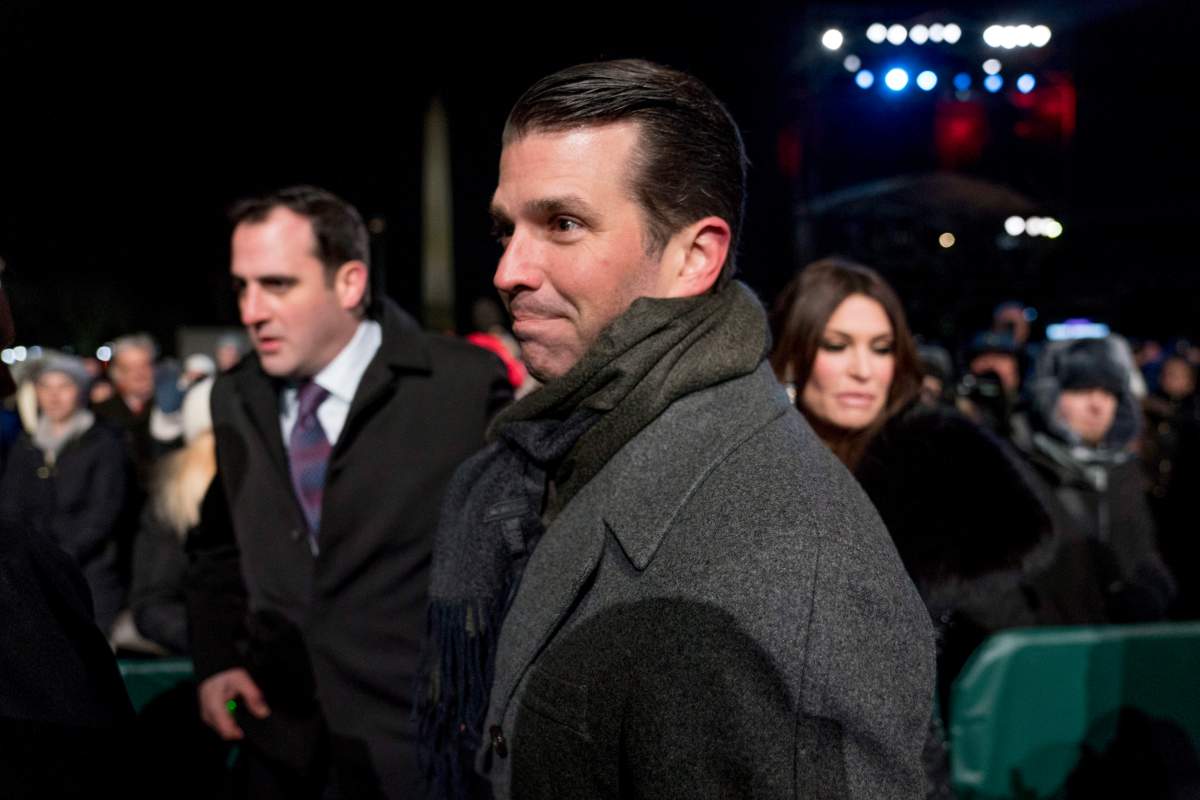 Donald Trump Jr., center, and Kimberly Guilfoyle, right, depart following the National Christmas Tree lighting ceremony at the Ellipse near the White House in Washington, Wednesday, Nov. 28, 2018.