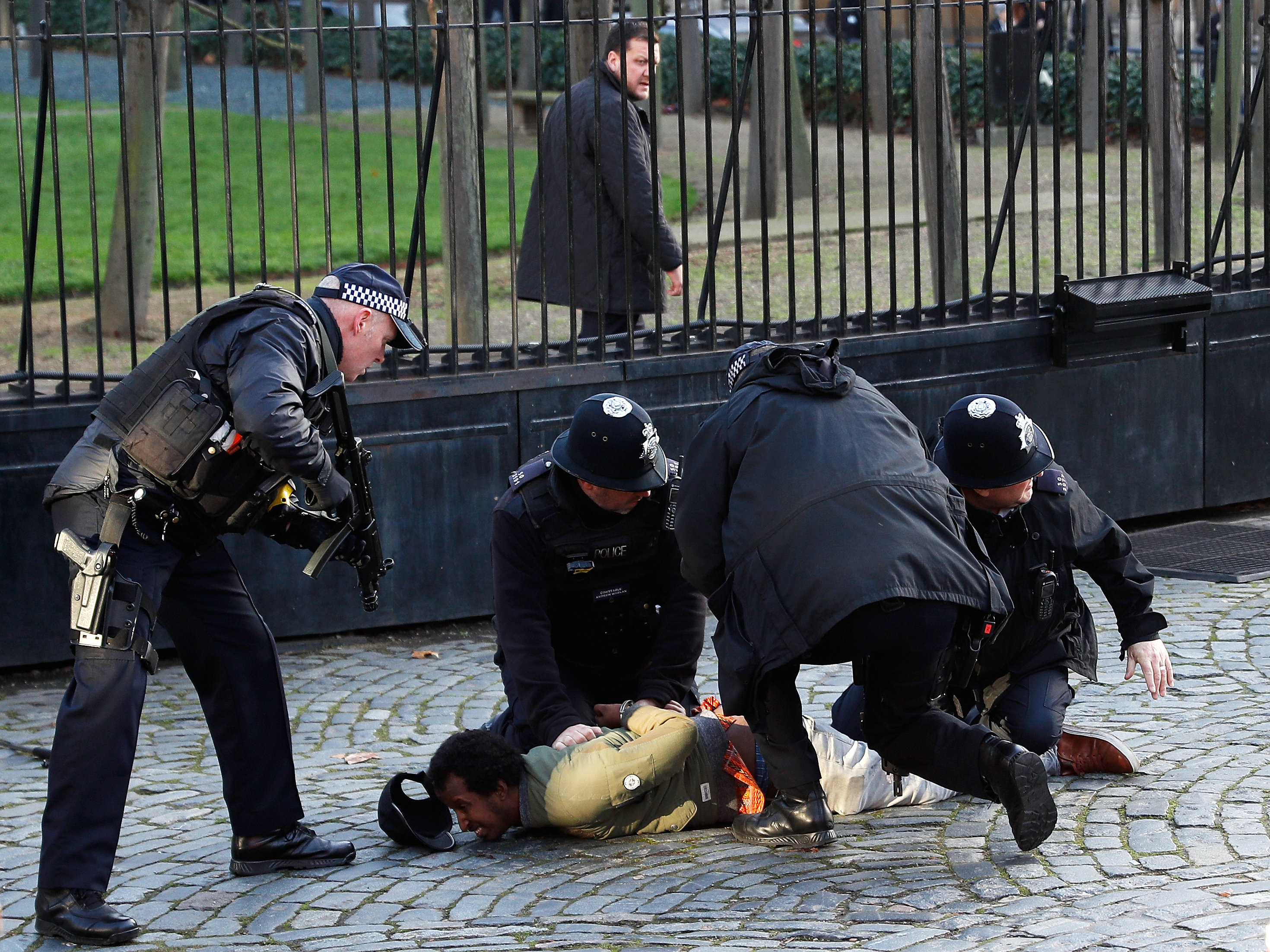 Police pin down, detain man inside grounds of British parliament ...