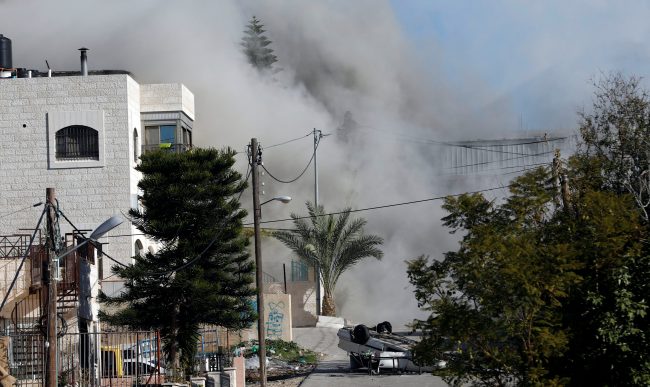 Smoke rises as Israeli forces blow up the house of Palestinian family Abu Humaid, in al-Amari refugee camp in Ramallah, in the Israeli-occupied West Bank December 15, 2018.