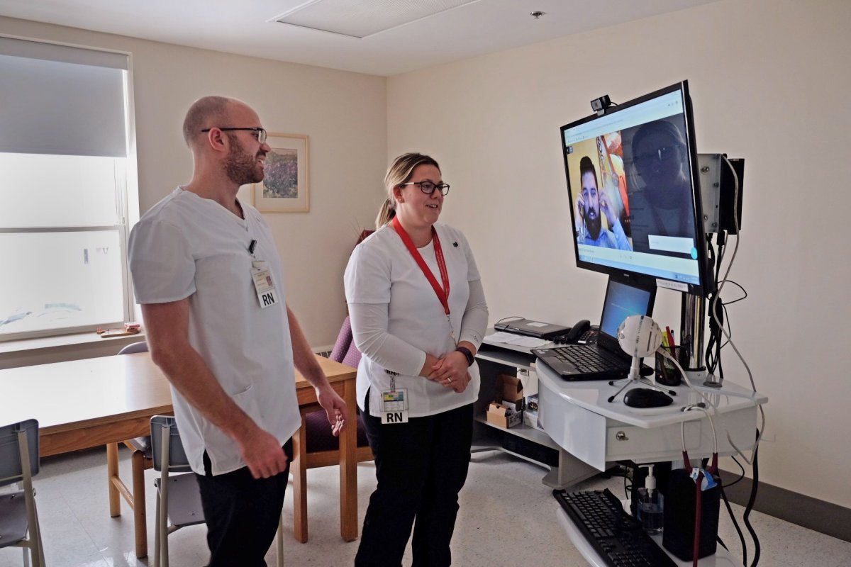Nurses use a TV cart with a doctor on a secure video conference link during a pilot project of "tele-rounding" in Alberton, P.E.I., in this undated handout photo. 