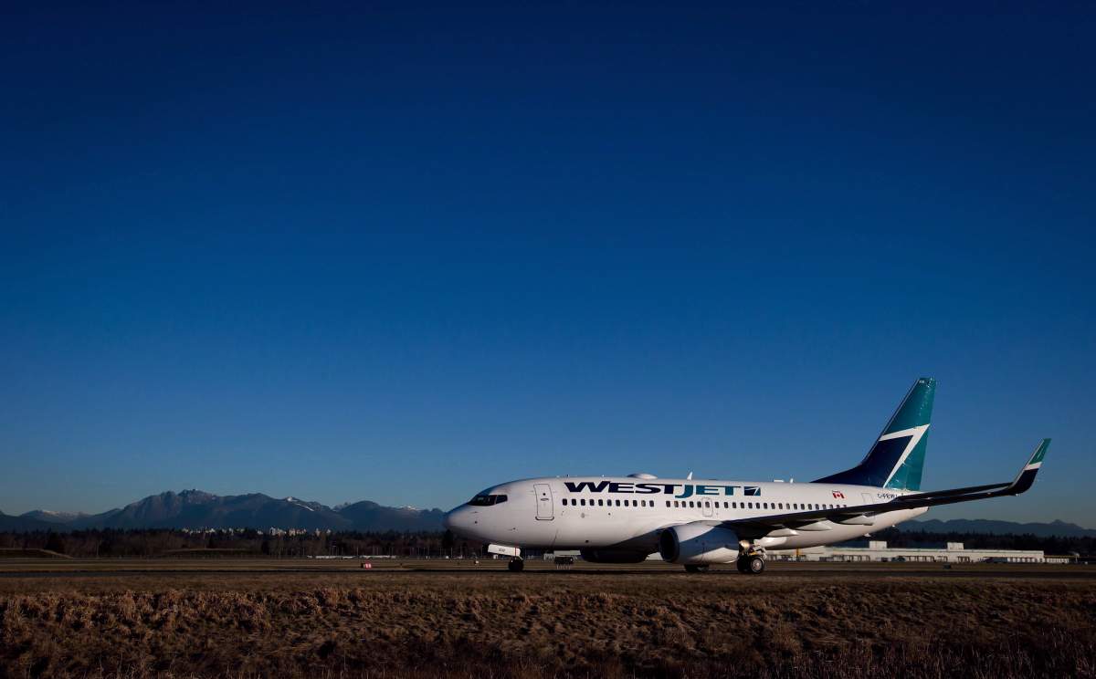 A Westjet Boeing 737-700 taxis to a gate after arriving at Vancouver International Airport in Richmond, B.C., on February 3, 2014. WestJet Airlines Ltd. says it is complying with a probe by Canada's competition watchdog following accusations of predatory pricing from a competitor. The Calgary-based carrier said in an email Wednesday it is "compiling information" in response to an investigation from the Competition Bureau. 