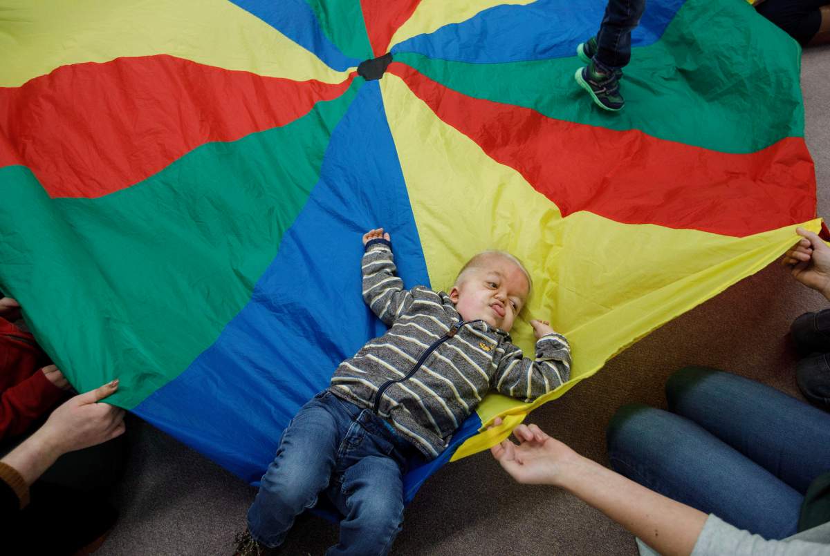 Porter Stanley takes part in the parachute game at preschool in Onoway, Alta., on Wednesday, November 7, 2018.