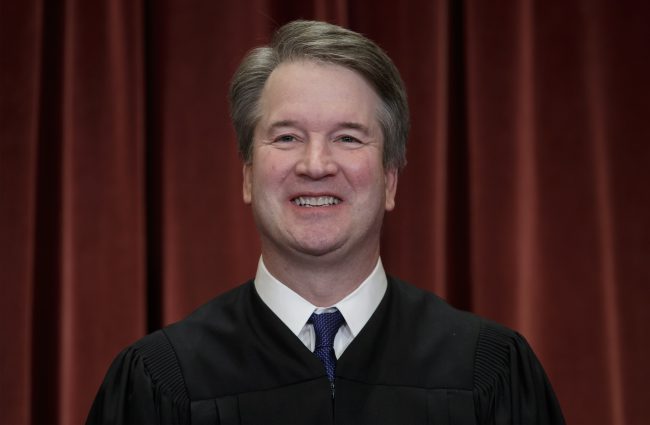 In this Nov. 30, 2018, file photo Associate Justice Brett Kavanaugh sits with fellow Supreme Court justices for a group portrait at the Supreme Court Building in Washington. 

