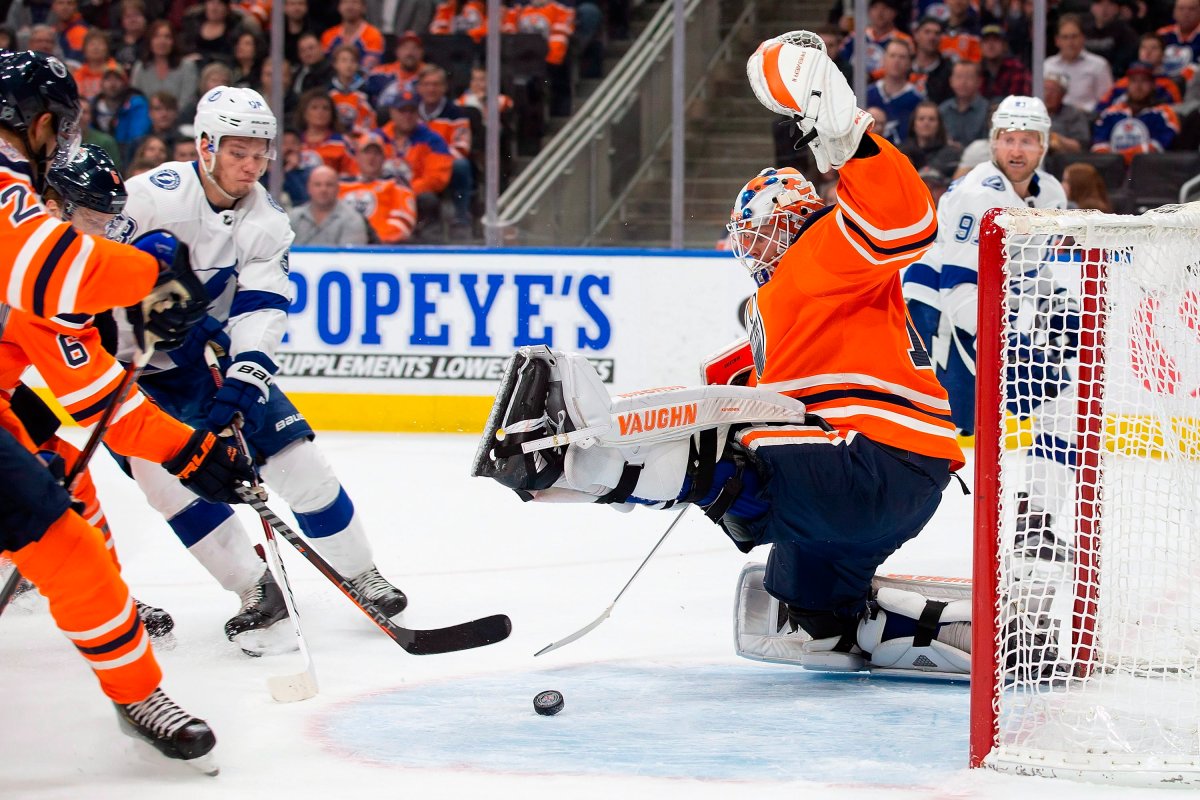 Edmonton Oilers goaltender Mikko Koskinen (19) makes a save against Tampa Bay Lightning defenseman Mikhail Sergachev (98) during first period NHL action at Rogers Place in Edmonton, Alta., on Saturday, Dec. 22, 2018. THE CANADIAN PRESS/Codie McLachlan.