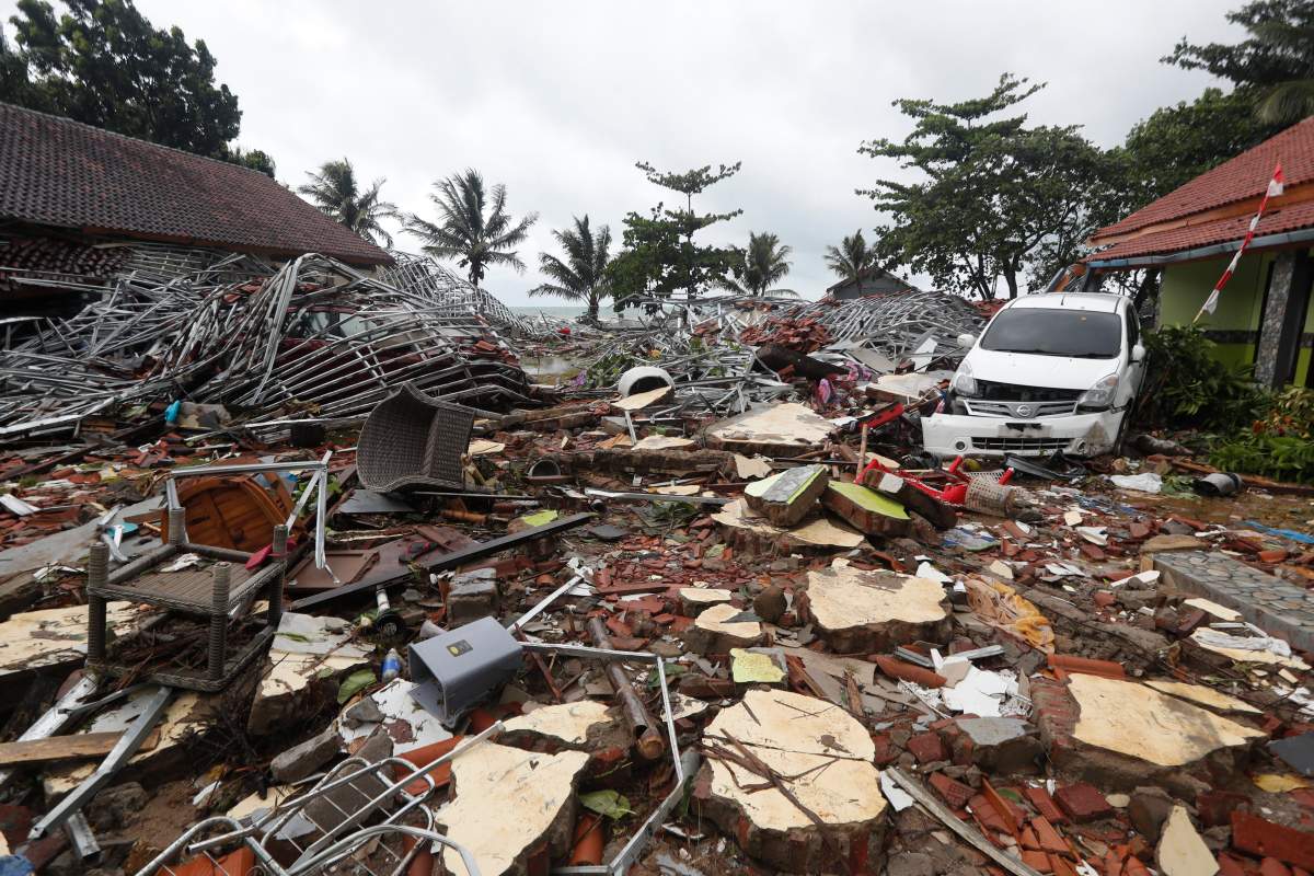 A view of the damage with a car sitting among debris after a tsunami hit the Sunda Strait in Pandeglang, Banten, Indonesia, Dec. 23, 2018.