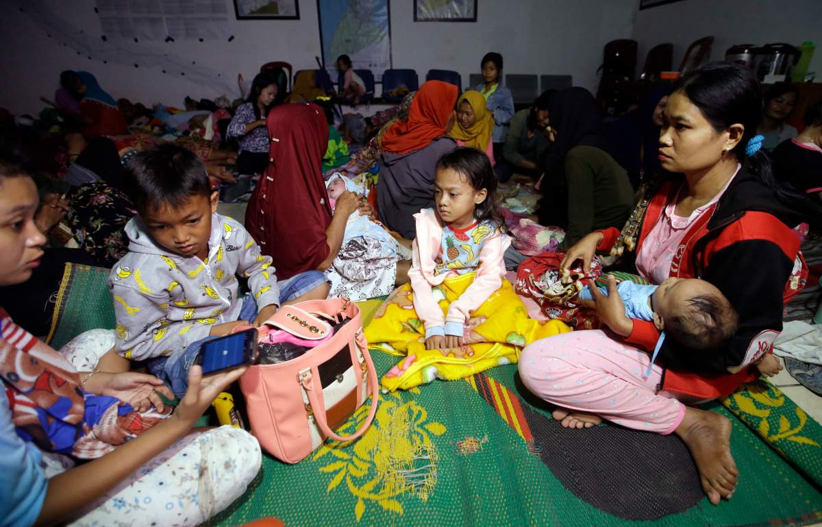 Tsunami survivors gather at a temporary shelter in Tanjung Lesung, Indonesia, Sunday, Dec. 23, 2018.