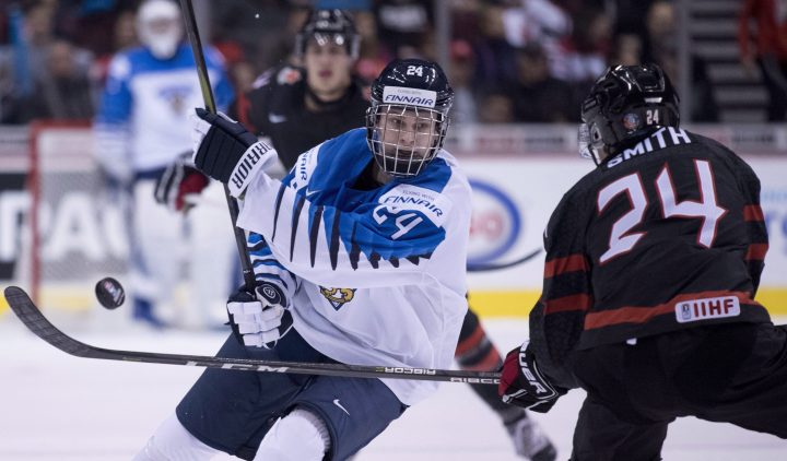 Team Canada’s Ty Smith fights for control of the puck with Team Finland’s Kaapo Kakko during third period IIHF exhibition hockey action at Rogers Arena in Vancouver, Sunday, Dec. 23, 2018. Hayward