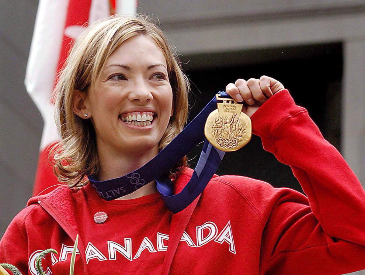 Canadian cross-country skier Beckie Scott displays her gold medal she was awarded at a ceremony in Vancouver, Friday, June 25, 2004.