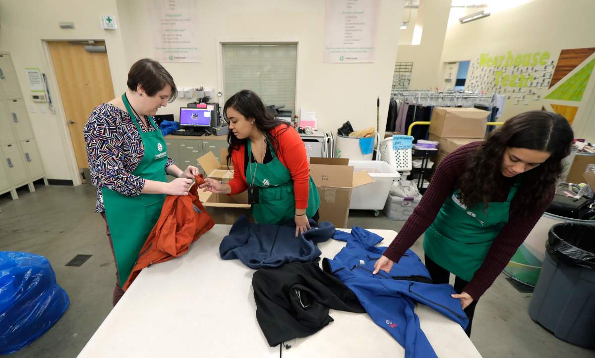 Rebecca Schaechter, Nicole Herron and Rachel Herron fold and sort donated clothes at Treehouse, a nonprofit organization in Seattle that serves the needs of children in the foster-care system. The charity was one of several that received donations from the $11-million secret estate of Alan Naiman.