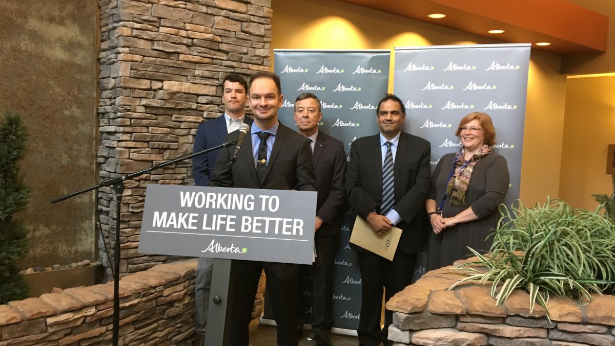 Ryan Coles, president of Canadian Condominium Institute (CCI), South Alberta Chapter; Minister Brian Malkinson; Anand Sharma, Canadian Condominium Institute, North Alberta Chapter; Bob MacLeod, Condominium Owners Forum Society of Alberta, and Jennifer MacFarlane, on-site property manager for The Wedgewoods, at the announcement of changes to the Condominium Property Regulation.