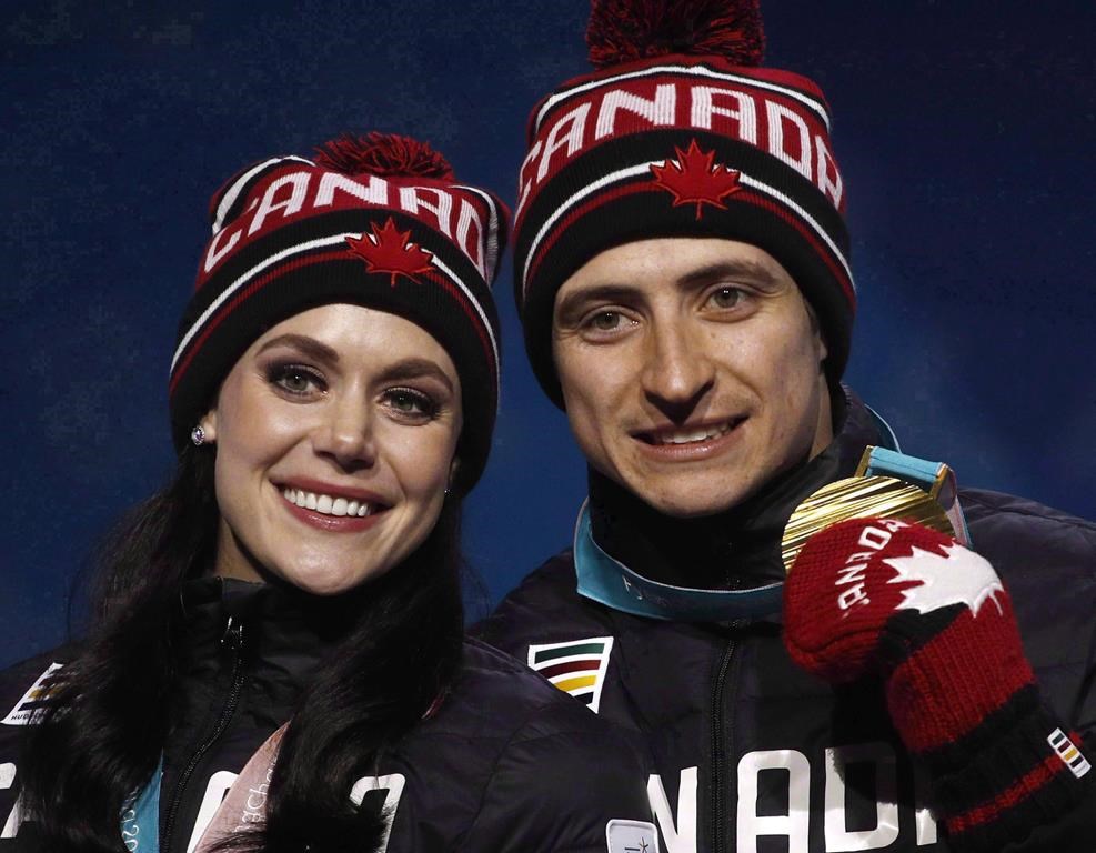 Ice dance gold medallists Tessa Virtue and Scott Moir, of Canada, pose during their medals ceremony at the 2018 Winter Olympics in Pyeongchang, South Korea, Tuesday, Feb. 20, 2018. THE CANADIAN PRESS/AP-Charlie Riedel