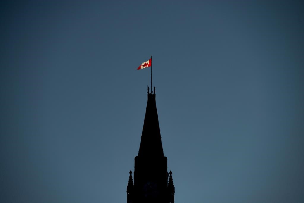 Ottawa ran a small surplus of $92 million through the first seven months of its fiscal year, compared with a deficit of nearly $6.6 billion in the same period last year as revenue has increased faster than spending. The Canadian Flag is illuminated by morning light atop the Peace Tower on Parliament Hill in Ottawa on Monday, Sept. 17, 2018.
