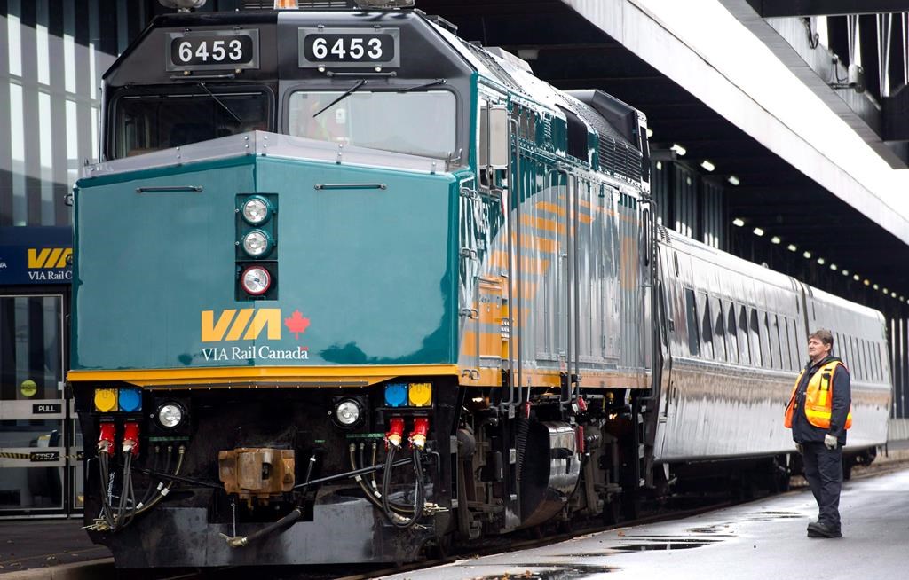 A VIA Rail employee stands on the platform next to an F40 locomotive at the train station in Ottawa on Dec. 3, 2012. THE CANADIAN PRESS/Adrian Wyld