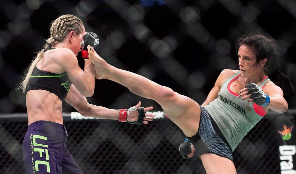 Valerie Letourneau, from Canada, right, lands a kick to the head of Jessica Rakoczy, from Canada, during their UFC 186 fight in Montreal on April 25, 2015. THE CANADIAN PRESS/Graham Hughes.